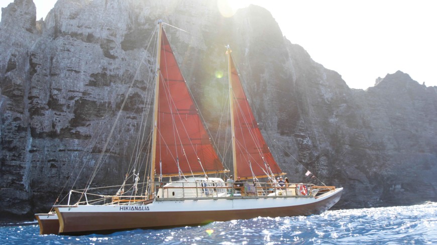 Hikianalia sails along side the steep cliffs of Nihoa.