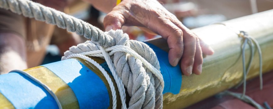 Using smaller line to seize the knot on the spar.
